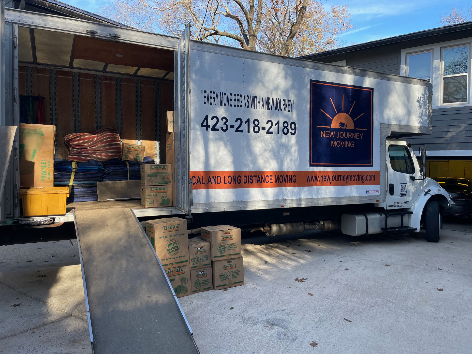 New Journey Moving truck loaded with packed boxes and furniture pads during a full-service white glove move in Chattanooga, TN